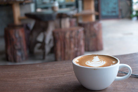 Close up of Cup of hot latte art coffee on wooden table.の写真素材