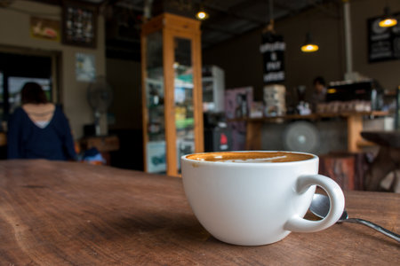 Close up of Cup of hot latte art coffee on wooden table.の写真素材