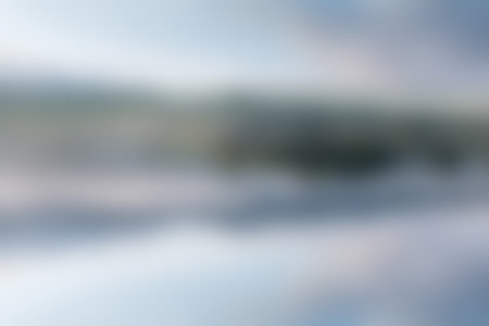 Outdoor blurred abstract background, beautifull lake with reflection on water.の写真素材