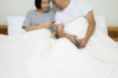 Blurred of lover couple on white bed for background.の写真素材