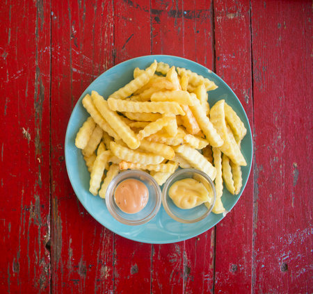 Closeup of French fries on white plate, Top views.