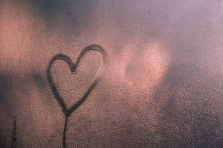 Heart shape on glass window with waterdrop concept design for valentine's day background or wedding background.の写真素材