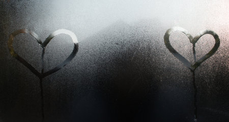 Heart shape on glass window with waterdrop concept design for valentine's day background or wedding background.の写真素材