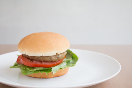 Closeup of Hamberger, It's junk food put on woodentable in food court.の写真素材