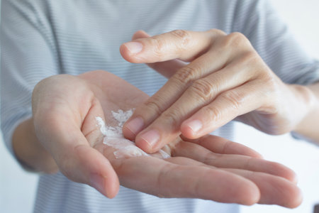 A woman is taking talcum powder to her hand.