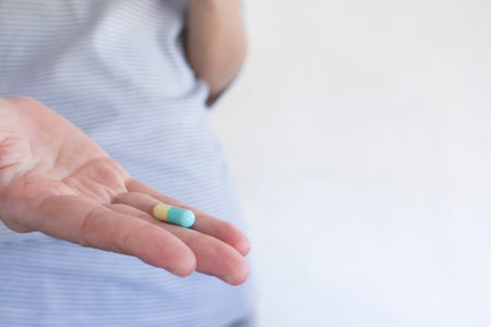 Hand holding capsule, Health care concept.の写真素材