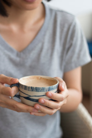 A Business woman is holding a white coffee cup.の写真素材