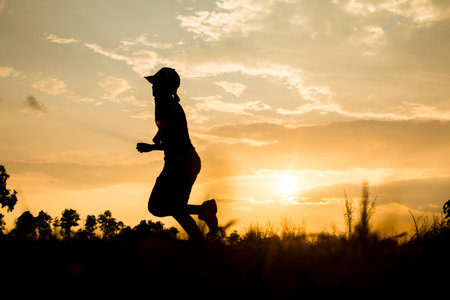 Fitness silhouette sunrise jogging workout wellness concept.の写真素材