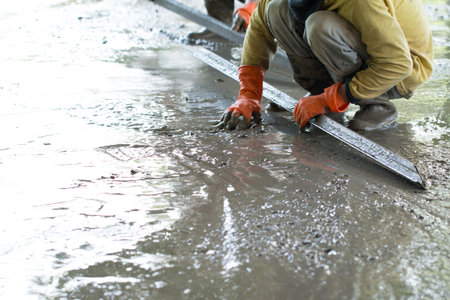 Construction worker is pouring concrete floors, Building construction on site with labor, Home building concept.の写真素材