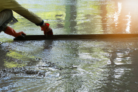 Construction worker is pouring concrete floors, Building construction on site with labor, Home building concept.の写真素材