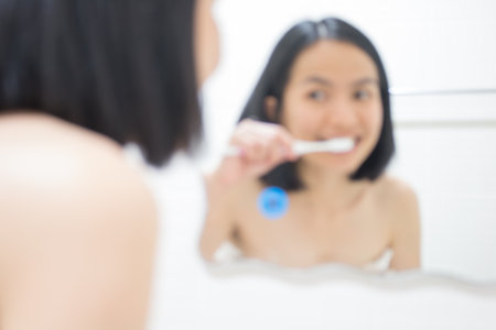 Blurred of A woman is brushing her teeth.の写真素材
