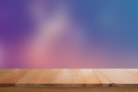 Wooden desk with Blurred light on road in city with bokeh abstract background