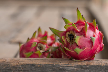 Red Dragon fruit or Tropical fruit on wooden desk background.の写真素材