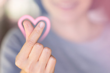 A woman Hand is making a heart sign.の写真素材
