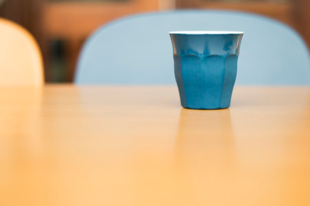 Blue ceramic tea cup on table.の写真素材