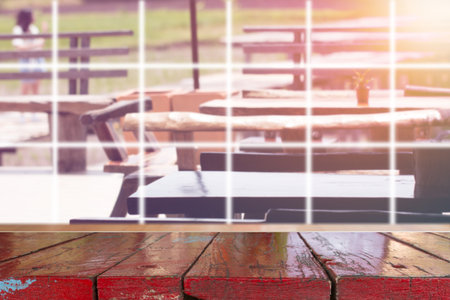 Wooden desk with blurred outdoor restaurant backgroundの写真素材