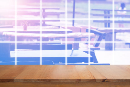 Wooden desk with blurred outdoor restaurant backgroundの写真素材