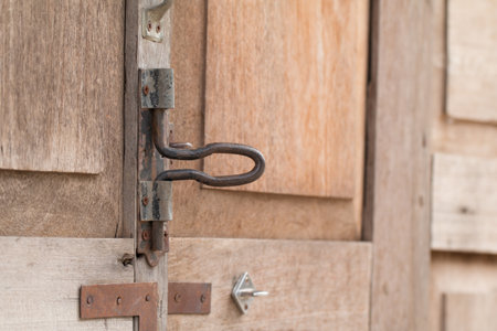 Metal old rusty handle on wooden door.の写真素材