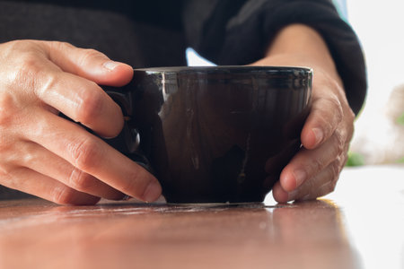 Woman enjoying warming drink, Late coffee.の写真素材