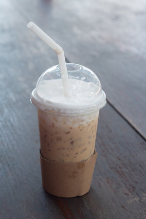 Glass of Cold Iced Coffee put on wooden table.の写真素材