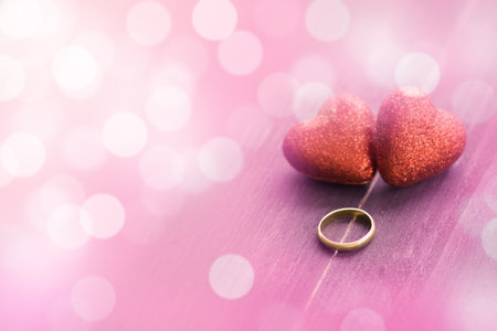 Valentines day concept, red decorate heart with golden ring on dark wooden  background design for greeting card.の写真素材