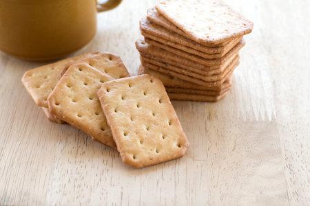 Milk cracker cookies Served with hot coffee on wooden desk ,Time break.の写真素材