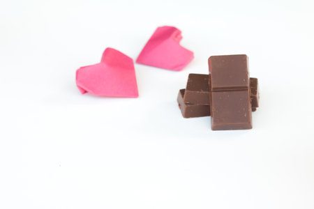 Chopped chocolate bars on white background.