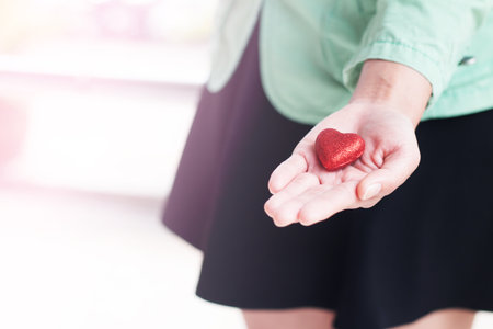 Decorative heart in woman hand, Valentine's day concept.の写真素材