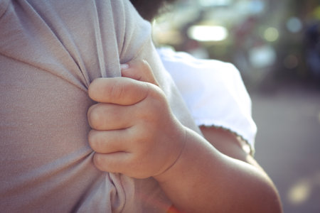 A little child hugging her mother in soft blurred background, Love of family concept.の写真素材