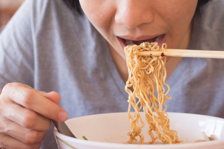 Young Asian woman is eating noodles, A Woman is having breakfast.の写真素材