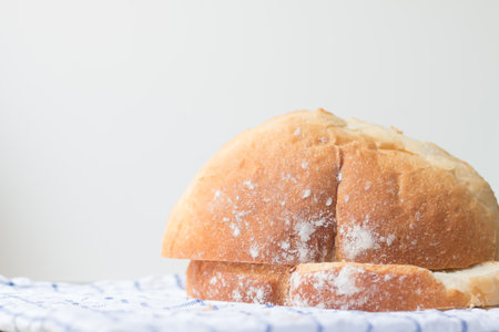 Fresh home made bread on white table background with napkin.の写真素材