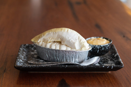 Cheesecake with topped Durian fruit and Durian cream on wooden desk background.の写真素材