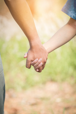 Lovers holding hands in out door or park.の写真素材