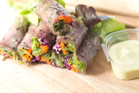 Fresh spring roll or Salad roll mixed by Vegetable carrot tuna on Chopping board in white background...