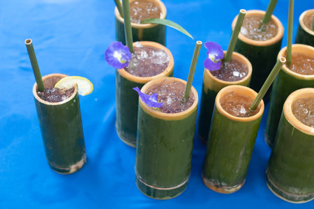 Cold healthy drink in natural bamboo mugs.の写真素材