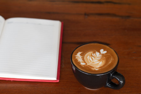 A cup of Piccolo Latte art  on wooden desk, Relaxing time or coffee's break time during work day.の写真素材