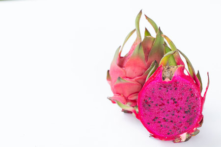 Fresh pitahaya fruit sliced on white background or ripe dragon fruit red color with copy-space design for drinks package design, healthy article picture and plantation guide book design.の写真素材