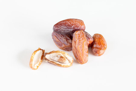 Close up of dried dates palm fruits on white background.