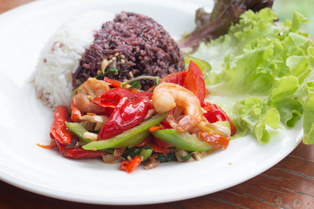 Rice topped with stir-fried shrimp and bell pepper.の写真素材