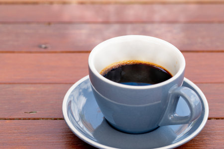 Cup of coffee on a wooden table.