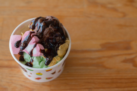 Homemade Organic Vanilla and Chocolate Ice Cream on wooden table.
