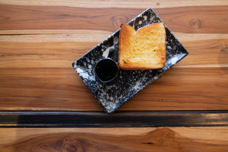 Butter and Sugar Toast with honey on wooden desk in coffee shop.の写真素材