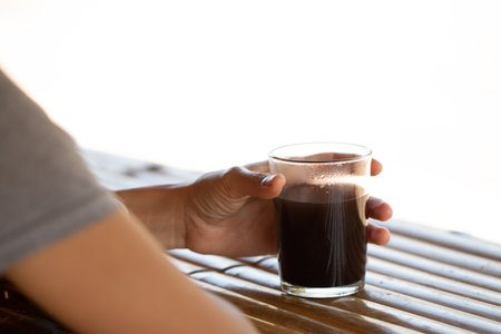 Girl holding cup of coffee in morning on Thailand coffee shop's style.の写真素材