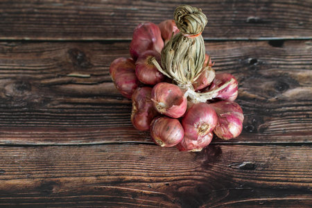 Fresh Shallot bunch on wooden table.の写真素材