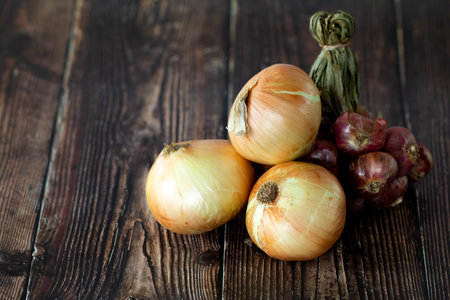 Fresh Shallot bunch and fresh onion on wooden table.の写真素材