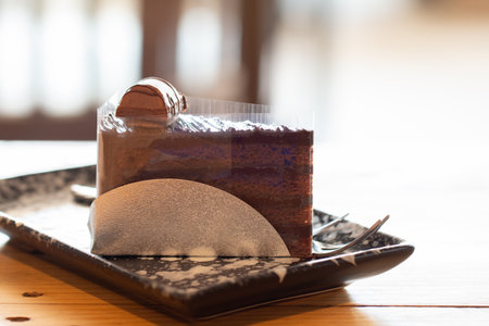 Close up of Chocolate cake sliced on wooden desk.の写真素材