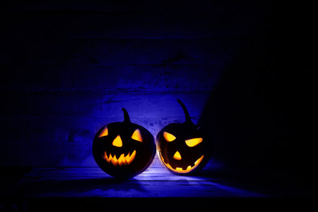 Halloween pumpkin head jack lantern in dark background.