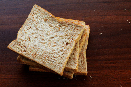 whole wheat bread on wooden table background, top view, copy space.の写真素材