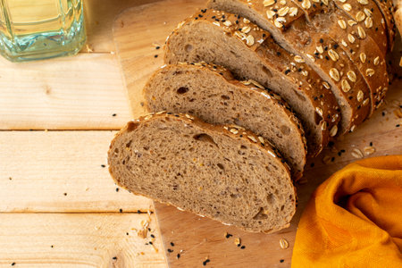 Sliced rye bread with sesame seeds and sesame oil on wooden tableの写真素材