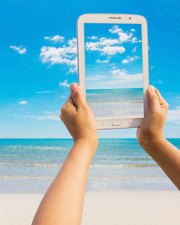 Tablet on the beach Thailand tripの写真素材